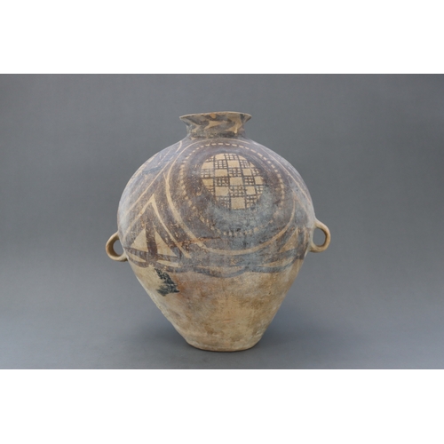 13 - A Majiayao Painted Pottery Handled Jar, Majiayao Culture, Machang Phase the ovoid body surmounted by... 