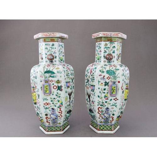 131 - A Pair of Moulded 'famille rose' Vases, 19th century, of shouldered form and hexagonal section,brigh... 