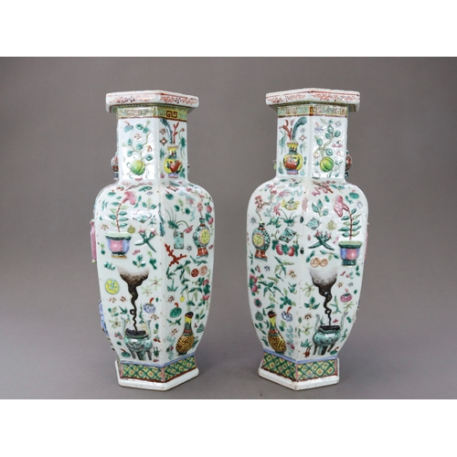 131 - A Pair of Moulded 'famille rose' Vases, 19th century, of shouldered form and hexagonal section,brigh... 