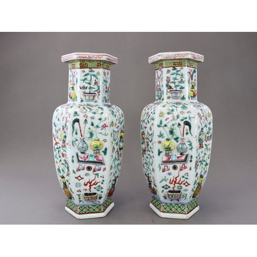 131 - A Pair of Moulded 'famille rose' Vases, 19th century, of shouldered form and hexagonal section,brigh... 