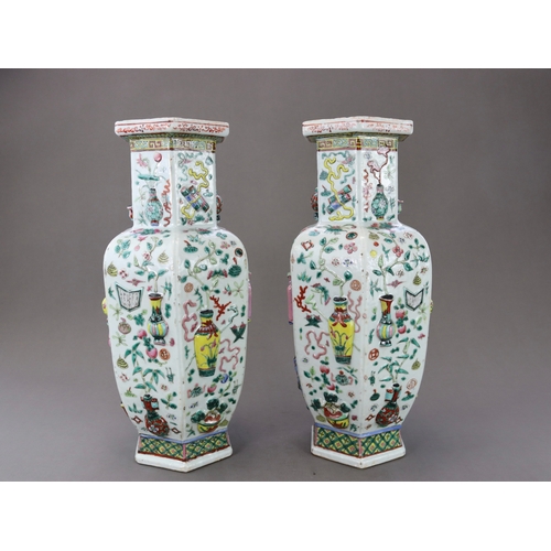 131 - A Pair of Moulded 'famille rose' Vases, 19th century, of shouldered form and hexagonal section,brigh... 