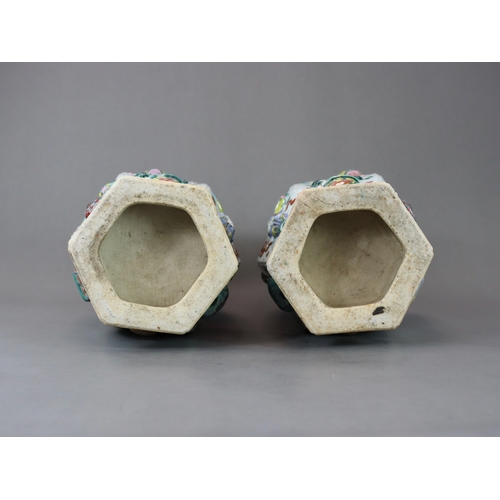 131 - A Pair of Moulded 'famille rose' Vases, 19th century, of shouldered form and hexagonal section,brigh... 