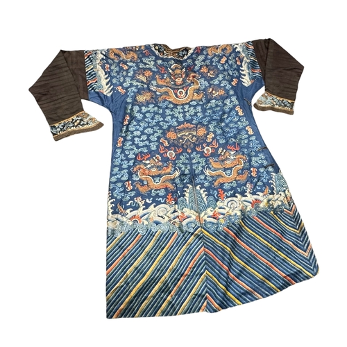 135 - An Embroidered Blue Ground Dragon Robe, 19th century with golden dragons among clouds, interspersed ... 