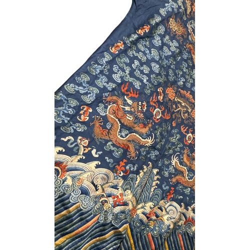 135 - An Embroidered Blue Ground Dragon Robe, 19th century with golden dragons among clouds, interspersed ... 