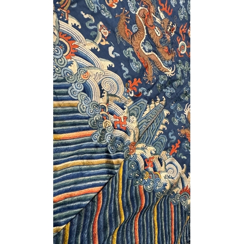 135 - An Embroidered Blue Ground Dragon Robe, 19th century with golden dragons among clouds, interspersed ... 