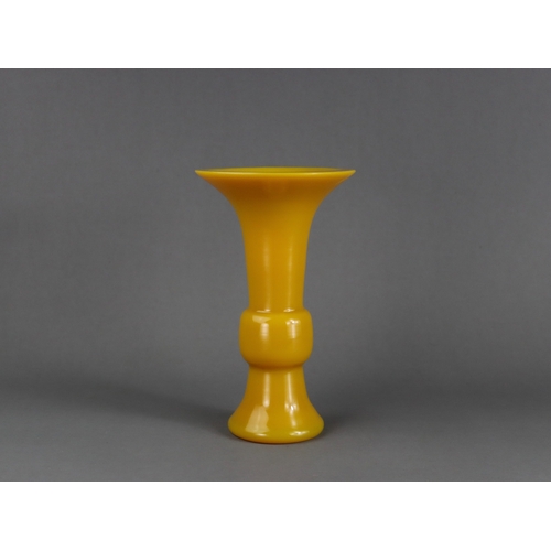 141 - A Yellow Pekin Glass Beaker Vase, gu, Qing dynasty,  the smooth entirely undecorated egg yellow vase... 