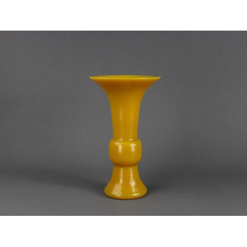 141 - A Yellow Pekin Glass Beaker Vase, gu, Qing dynasty,  the smooth entirely undecorated egg yellow vase... 