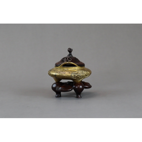 159 - A Fine Gilt Bronze Tonkin Ware Tripod Censer, liding, 18th century,  of compressed circular form on ... 