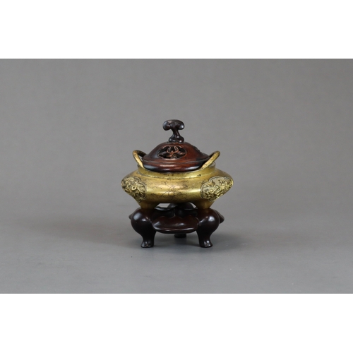 159 - A Fine Gilt Bronze Tonkin Ware Tripod Censer, liding, 18th century,  of compressed circular form on ... 