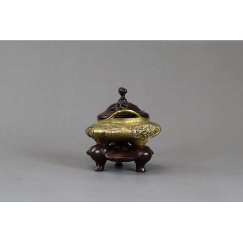 159 - A Fine Gilt Bronze Tonkin Ware Tripod Censer, liding, 18th century,  of compressed circular form on ... 