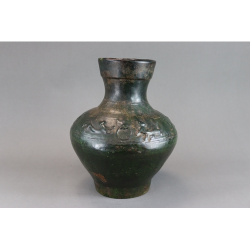 16 - A Green glazed Pottery Vase, hu, Han dynasty moulded in low relief around the shoulder beneath  the ... 