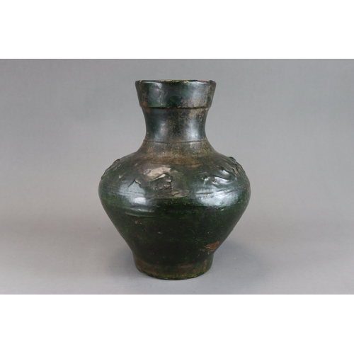 16 - A Green glazed Pottery Vase, hu, Han dynasty moulded in low relief around the shoulder beneath  the ... 