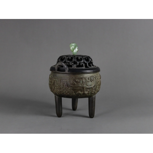 163 - A Bronze Tripod Censer, liding, Qing dynasty, well decorated around the exterior in crisp low relief... 