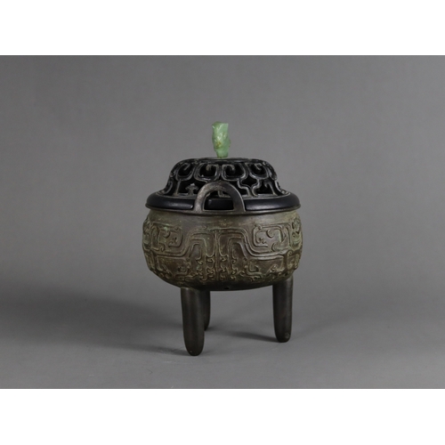 163 - A Bronze Tripod Censer, liding, Qing dynasty, well decorated around the exterior in crisp low relief... 