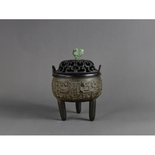 163 - A Bronze Tripod Censer, liding, Qing dynasty, well decorated around the exterior in crisp low relief... 