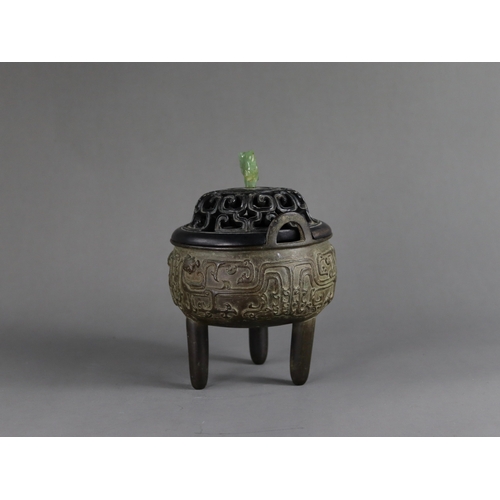 163 - A Bronze Tripod Censer, liding, Qing dynasty, well decorated around the exterior in crisp low relief... 