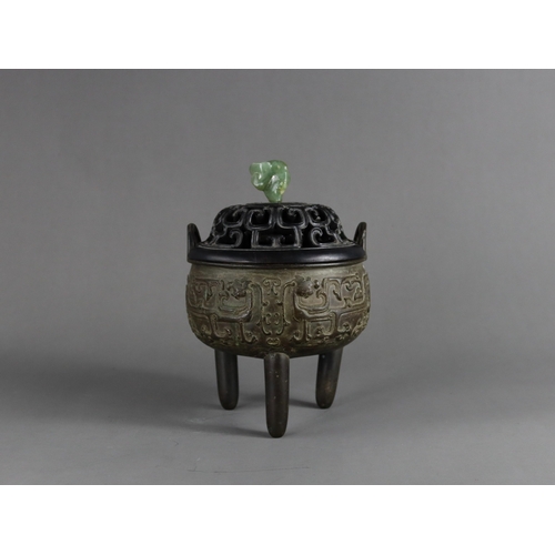 163 - A Bronze Tripod Censer, liding, Qing dynasty, well decorated around the exterior in crisp low relief... 