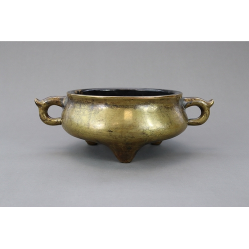 165 - A Bronze Tripod Censer, Qing dynasty, the massively cast undecorated censer of wide bombe form, stan... 