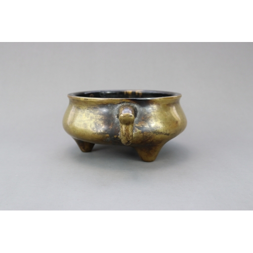 165 - A Bronze Tripod Censer, Qing dynasty, the massively cast undecorated censer of wide bombe form, stan... 