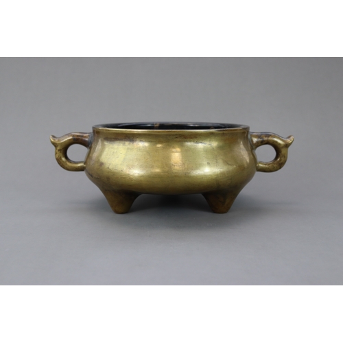 165 - A Bronze Tripod Censer, Qing dynasty, the massively cast undecorated censer of wide bombe form, stan... 