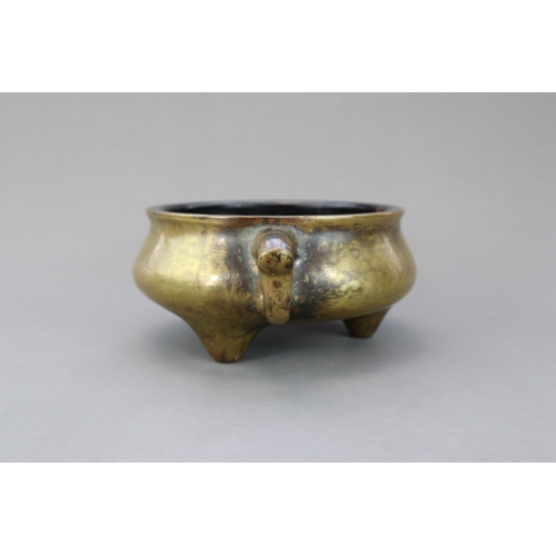 165 - A Bronze Tripod Censer, Qing dynasty, the massively cast undecorated censer of wide bombe form, stan... 