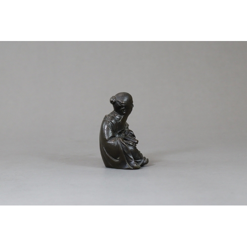 166 - A Bronze Seated Sage, 17th century,  with long beard and serene gaze,  finely cast leaning on a rock... 