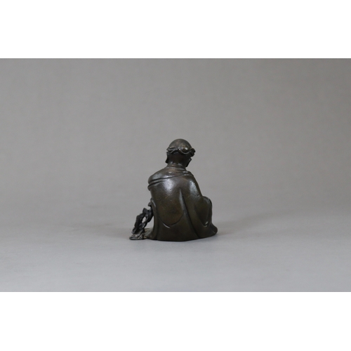 166 - A Bronze Seated Sage, 17th century,  with long beard and serene gaze,  finely cast leaning on a rock... 