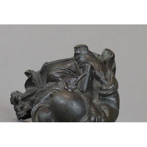 166 - A Bronze Seated Sage, 17th century,  with long beard and serene gaze,  finely cast leaning on a rock... 