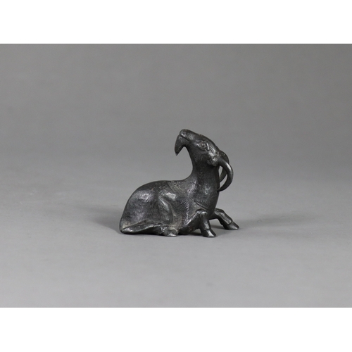 167 - A Bronze Goat Paperweight, Qing dynasty,  the seated long horned beast with head raised, looking ale... 