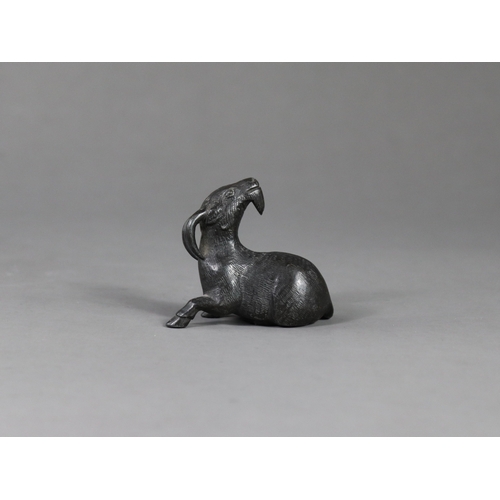 167 - A Bronze Goat Paperweight, Qing dynasty,  the seated long horned beast with head raised, looking ale... 