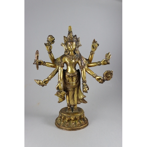 168 - A Rare Gynandromorphic Gilt Bronze Bodhisattva, 18/19th century,  the finely worked eight armed deit... 