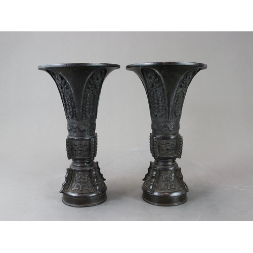 171 - A Good Pair of Bronze Beaker Vases, gu, 18th century,  well cast and with dark patination, the centr... 