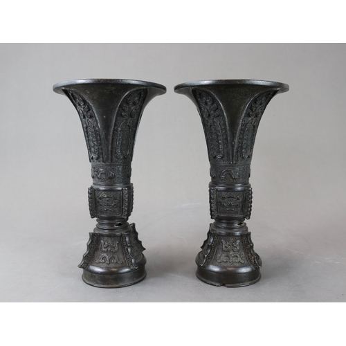 171 - A Good Pair of Bronze Beaker Vases, gu, 18th century,  well cast and with dark patination, the centr... 