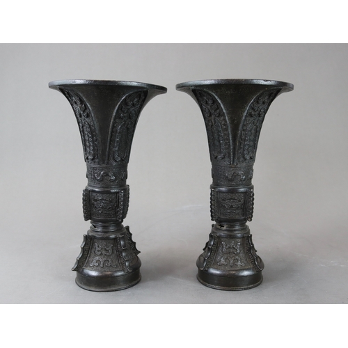 171 - A Good Pair of Bronze Beaker Vases, gu, 18th century,  well cast and with dark patination, the centr... 