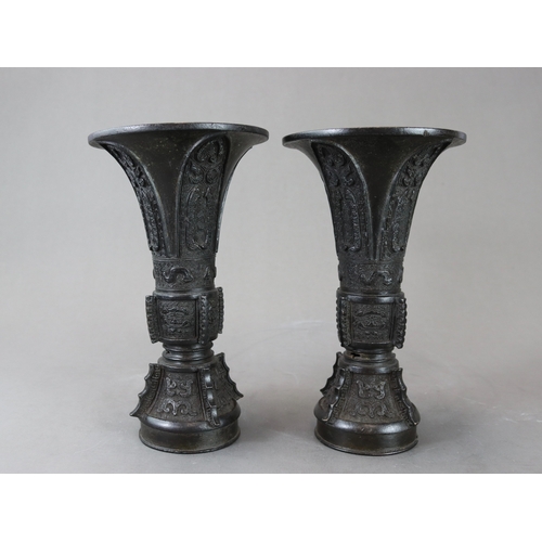 171 - A Good Pair of Bronze Beaker Vases, gu, 18th century,  well cast and with dark patination, the centr... 