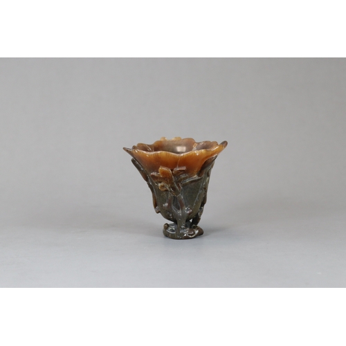 172 - A Rhinoceros Horn Libation Cup, 17th/18th century,  well carved in high and pierced relief as a larg... 