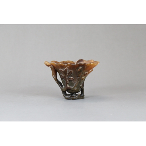 172 - A Rhinoceros Horn Libation Cup, 17th/18th century,  well carved in high and pierced relief as a larg... 