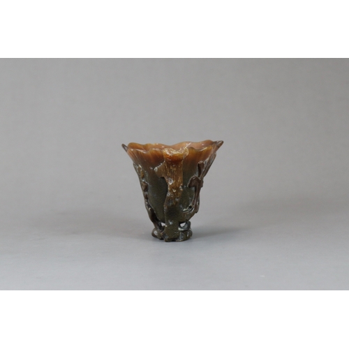 172 - A Rhinoceros Horn Libation Cup, 17th/18th century,  well carved in high and pierced relief as a larg... 