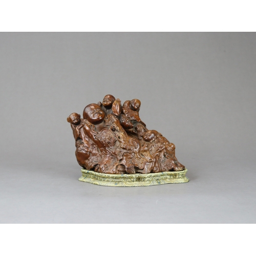 175 - A Good Rootwood Group with Budai, Qing dynasty, expressively carved with the fat and cheerful deity ... 