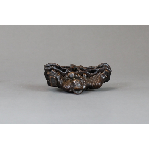 176 - A Bamboo Scholar Brushrest, 17th century,  sensitively carved depicting the smiling scholar reclinin... 