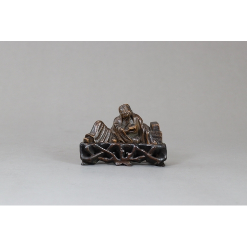 176 - A Bamboo Scholar Brushrest, 17th century,  sensitively carved depicting the smiling scholar reclinin... 