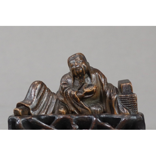 176 - A Bamboo Scholar Brushrest, 17th century,  sensitively carved depicting the smiling scholar reclinin... 