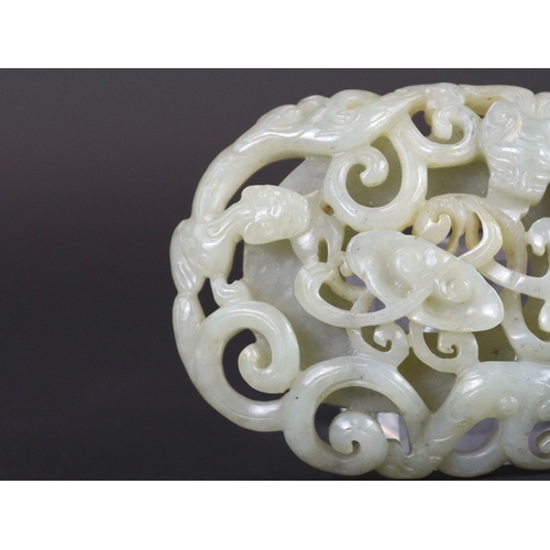 178 - A Jade Double Chilong Plaque, Ming dynasty,  of slightly domed oval form, softly carved in deep open... 