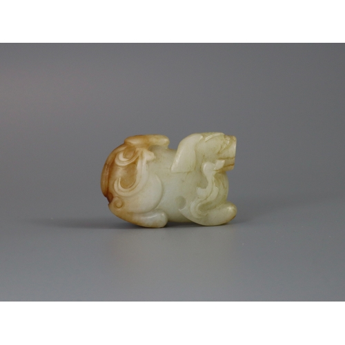 184 - A Seated Jade Lion, Yuan/Ming dynasty,  carved from pale celadon stone with russet inclusions, the f... 