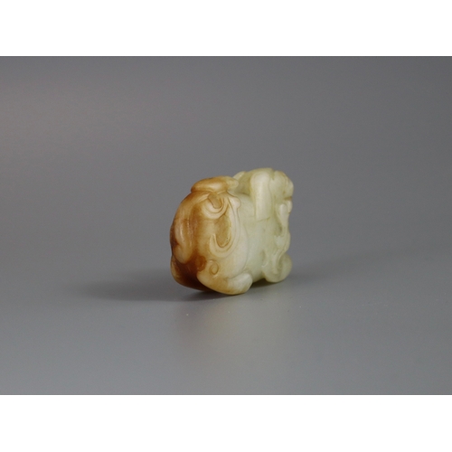 184 - A Seated Jade Lion, Yuan/Ming dynasty,  carved from pale celadon stone with russet inclusions, the f... 