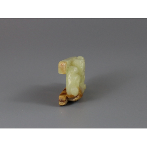 185 - A Jade Chilong Pendant, Yuan/Ming dynasty,  well carved in low pierced relief with a coiled chilong ... 