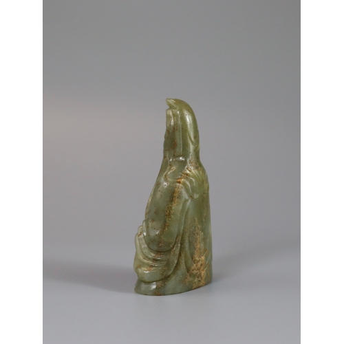 191 - A Jade Guanyin, 17th century,  carved from an olive green stone, the serene deity seated upright, we... 