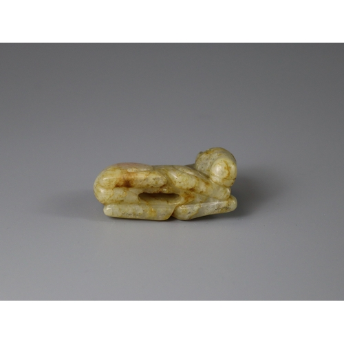 192 - A Jade Seated Horse, 17th century,  softly carved from a greyish celadon stone with faint russet suf... 