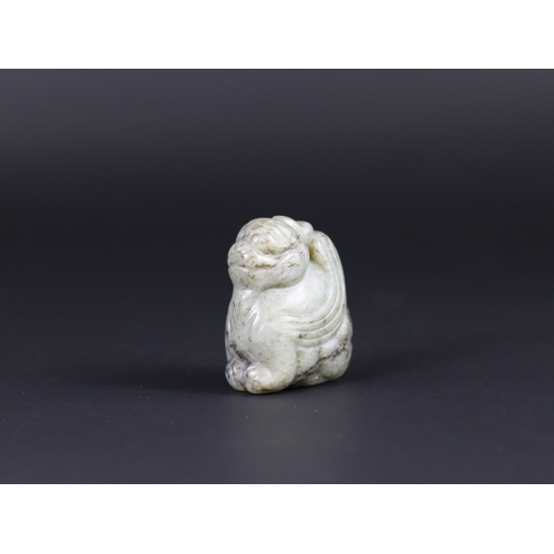 194 - A Grey Jade Fabulous Animal Pendant, Ming dynasty,  the softly carved winged horned beast seated upr... 