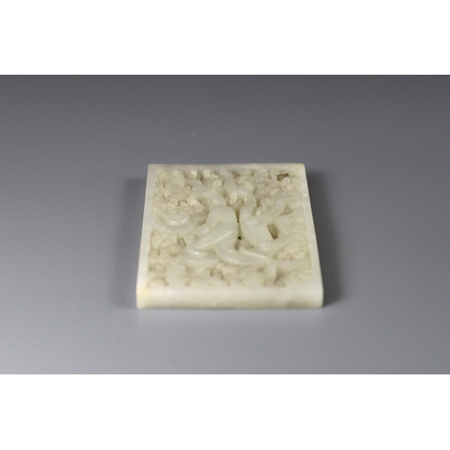 196 - A Good White Jade Dragon Belt Plaque, Ming dynasty, of rectangular form, carved and pierced in low o... 